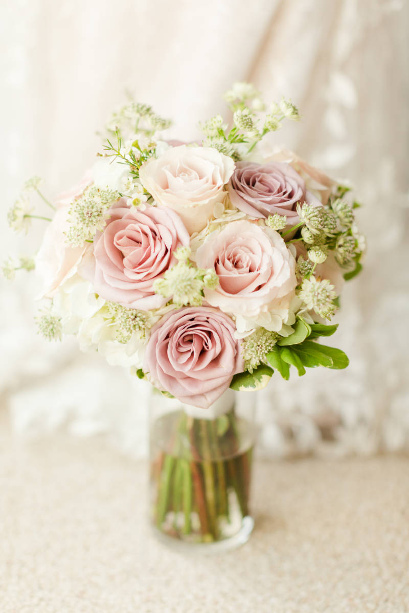 Outer Banks florals Bridal bouquet elegant pastel pink roses with small white flowers and greenery in a vase